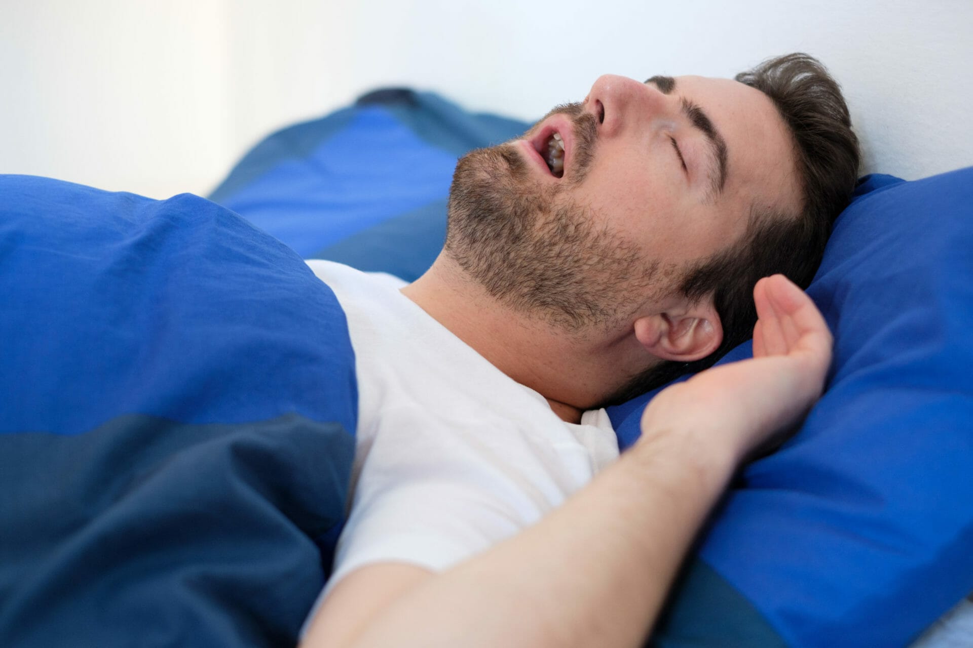 Man with sleep apnea in bed